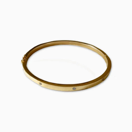 Gold bangle on a white background