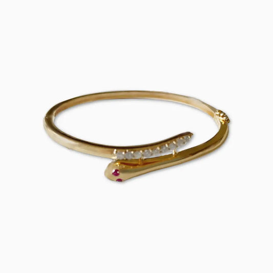 Gold bracelet with a snake design on a white background